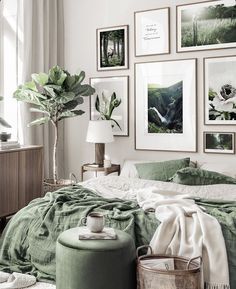 a bedroom with green bedding and pictures on the wall above it's bed