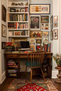 a home office with bookshelves and pictures on the wall