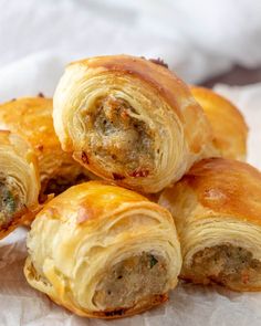 several sausage rolls are piled on top of each other