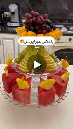 fruit platter with grapes, melon, kiwis and bananas on it