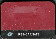 a close up of a red and black sign with the word rencarnate on it