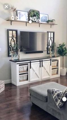 a living room filled with furniture and a flat screen tv on top of a wall