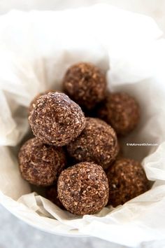 a white bowl filled with chocolate truffles on top of a table