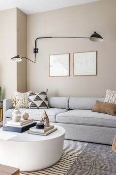 a living room filled with furniture and decor on top of a white table in front of a window