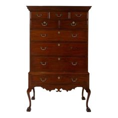 an antique chest of drawers with brass handles and knobs on the front, against a white background