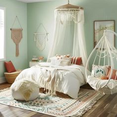 a bedroom with a hammock bed, rugs and pictures on the wall