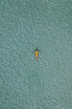 an aerial view of a person swimming in the ocean