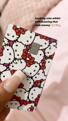 someone is holding up a hello kitty credit card