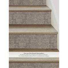 the stairs are decorated with damask wallpaper and wood flooring in shades of gray