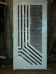 a white door with black lines painted on the front and side panels, in a room under construction