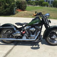 a black motorcycle parked on top of a driveway