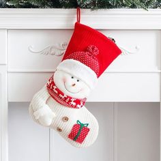 a snowman stocking hanging from a mantle