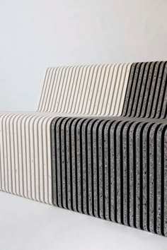 two black and white striped benches sitting next to each other on top of a floor