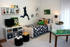 a bedroom with soccer themed decor and furniture