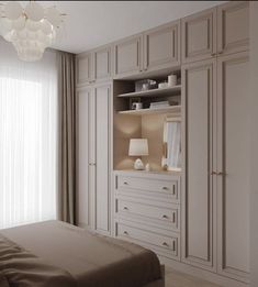 a bedroom with white cabinets and a large chandelier hanging from the ceiling above it