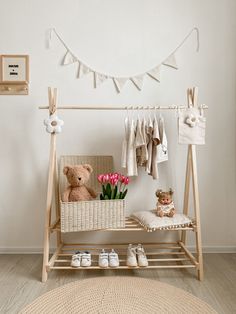 a teddy bear sitting on a bench next to a basket with tulips