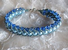 "The sophisticated color of blue combine with an accent color of light blue pearl makes the bracelet with a daintiness of the sky. This bracelet is hand stitch using Czech glass pearls, swarovski crystal and Japanese seed beads. It is finished off with a silver tone magnetic clasp for an easy wear. The bracelet measures 7 1/4\" and will fit 6 1/2\" to 7\" wrist comfortably and if you prefer this in different LENGTH and COLOR, custom work are welcome just convo me and it will be ship the next day Elegant Blue Beaded Crystal Bracelet, Blue Pearl Bracelets For Jewelry Making, Adjustable Blue Beaded Bracelets For Wedding, Elegant Handmade Light Blue Beaded Bracelets, Blue Pearl Beaded Bracelets For Gifts, Blue Pearl Bracelet Gift, Blue Jubilee Crystal Bracelet With Round Beads, Elegant Blue Handmade Bracelets, Elegant Handmade Light Blue Crystal Bracelet