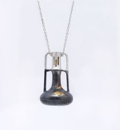 Experience the artistry of handcrafted jewelry with this stunning necklace. The Kumboo technique and oxidation create a captivating contrast between 24K gold foils and sterling silver. This unique piece doubles as a perfume and essential oil diffuser, adding both style and practicality to your collection. Vase Necklace, Essential Oil Necklaces, Urn Pendant, Diffuser Jewelry, Urn Necklaces, Stunning Necklace, Oil Diffuser, Essential Oil Diffuser, Gold Foil