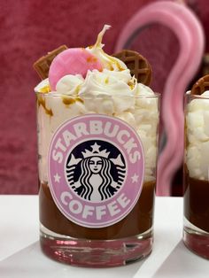 two cups filled with hot chocolate and whipped cream