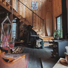 a living room filled with furniture and wooden walls