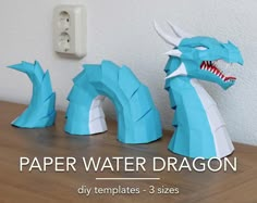 paper water dragon sculptures on a table with the words paper water dragon written below them