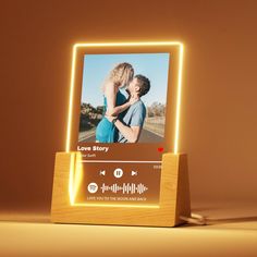 an illuminated photo frame with the image of a man and woman in love on it