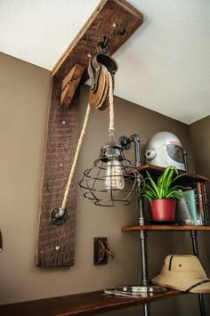 a wooden shelf with a lamp and some plants on it next to a hat rack