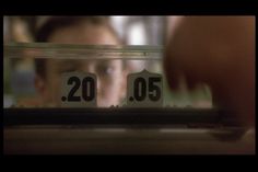 a person looking through a glass window with the numbers 20 and 50 in front of them