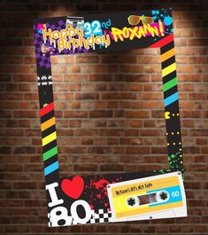 a digital file is on display in front of a brick wall with an i love 80th birthday sticker