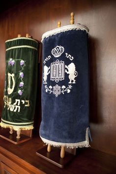 two towels are sitting on top of a shelf