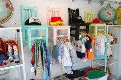 a room filled with lots of children's clothing on shelves next to each other