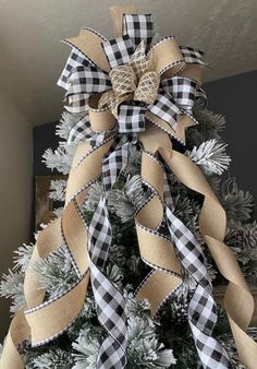 a christmas tree decorated with burlocks and ribbon