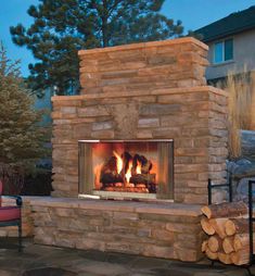 an outdoor fireplace with logs in front of it