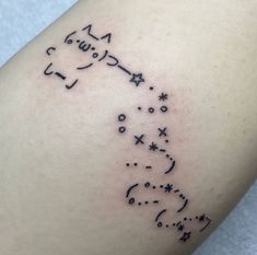 a small tattoo on the leg of a woman's arm with stars and an arrow