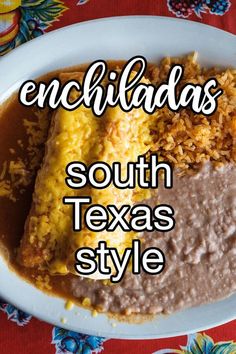 an enchiladas dish on a plate with rice, beans and other foods