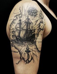 a woman's arm with a ship and an anchor on the map in black ink