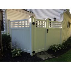 a white fence in front of a house