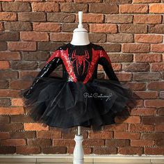 a black and red spiderman tutule dress on a mannequin stand