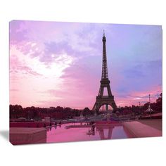 the eiffel tower in paris at sunset with pink sky and clouds behind it