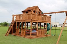 a wooden swing set in the middle of a field