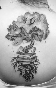 a woman's back with a tree and books on it