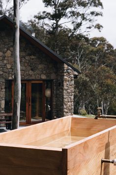 a wooden box sitting in front of a stone building