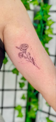 a woman's arm with a tattoo on it that has a flower in the middle