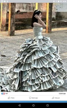 a woman in a dress made out of newspapers