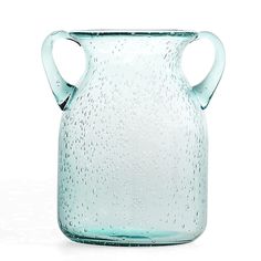 a glass vase with water droplets on the outside and inside it's handle is shown in front of a white background