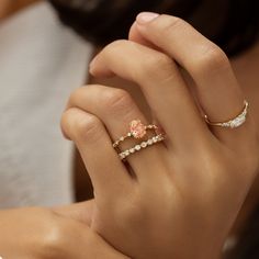 a woman's hand with two rings on it and one is holding the other