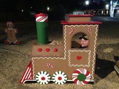 a man in a cardboard train with gingerbreads and candy canes on it