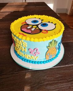 a spongebob themed birthday cake on a wooden table