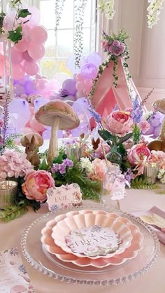 a table topped with lots of pink and purple decorations