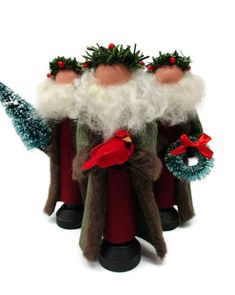 three christmas gnomes are standing next to each other